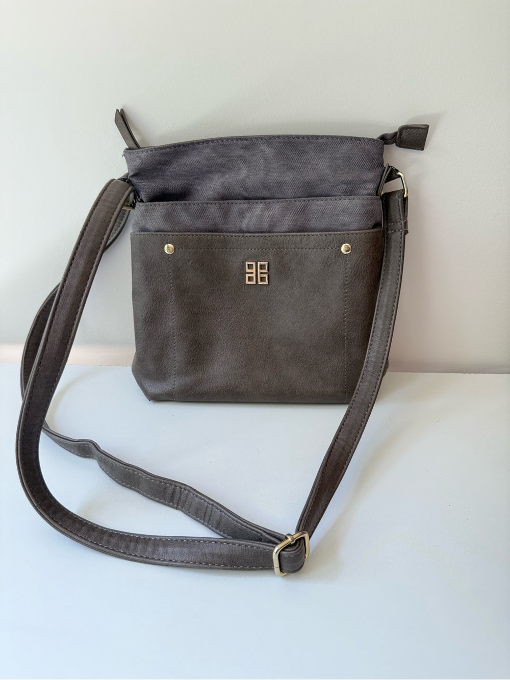 Blush black Crossbody Bag with Front Pocket and Gold Emblem
